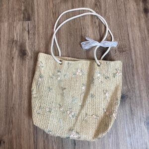 unbranded cream and blue floral woven straw bag with white cord and bow